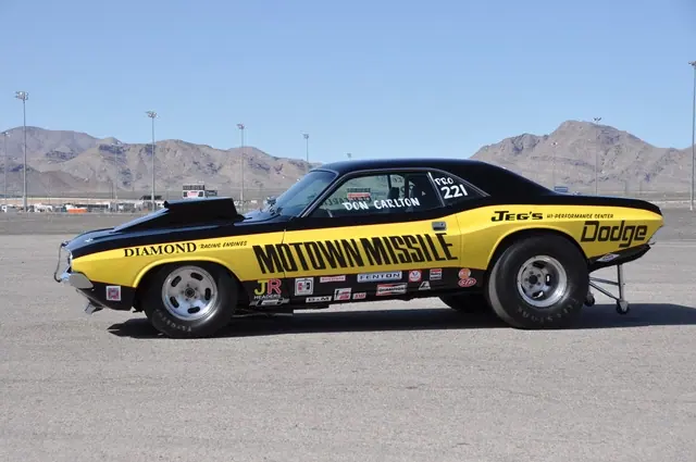 Side profile of the black-and-yellow Motown Missile Challenger on pavement