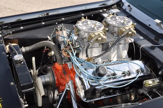 Left-side view of the HEMI engine bay with twin carburetors and polished valve cover