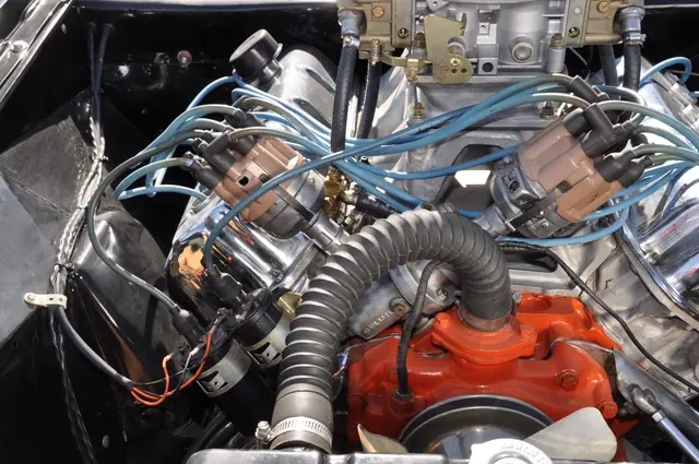 Engine detail showing two distributors with blue ignition wires