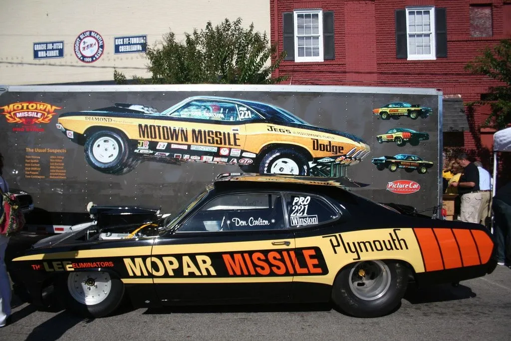 Mopar Missile drag car beside a trailer depicting the Motown Missile